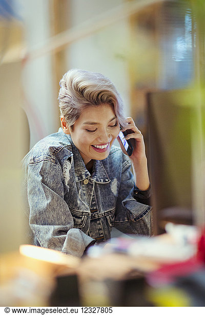 Smiling young woman talking on smart phone