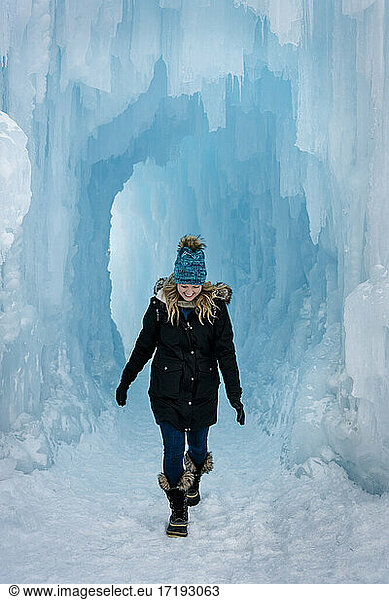 Smiling young woman walking in Ice Castles
