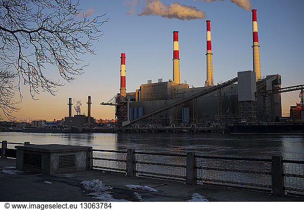 Smoke Stacks in factory against clear sky