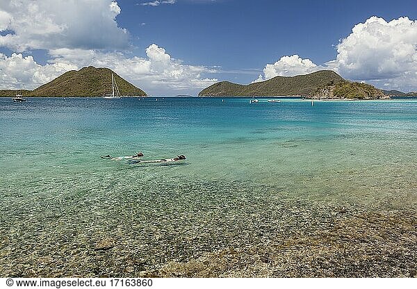 Snorkelers in Leinster Bay with boats in harbor on the island of St. John in the United States Virgin Islands.