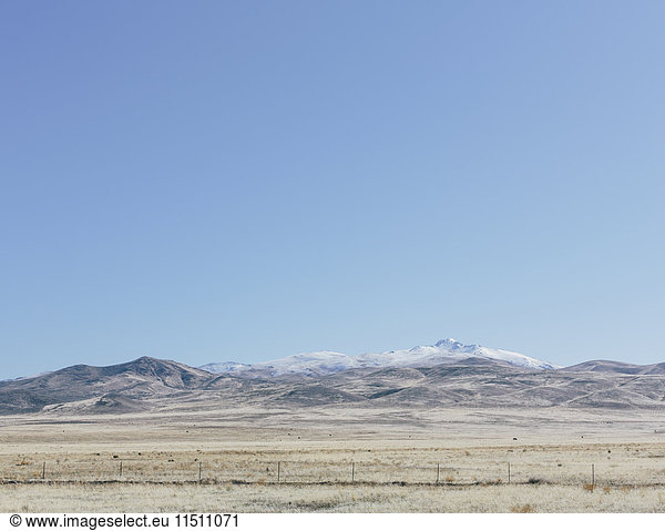Snow capped mountains and farmland in rural Nevada  USA.