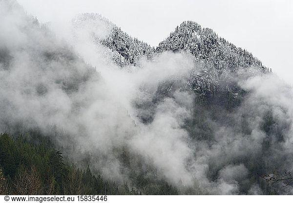Snow Covered Mountain Peaks With Fog