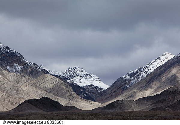Snow covered mountains and an ominous sky  in Panamint Mountains  in Death Valley national park.