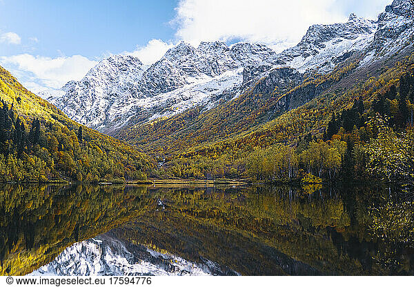 Snow covered mountains reflecting on lake in autumn  Caucasus Nature Reserve  Sochi  Russia