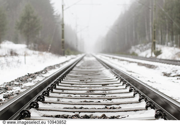 Snow covered railroad track at countryside