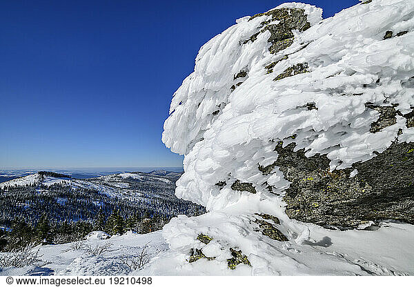 Snow covered rock formation on mountain