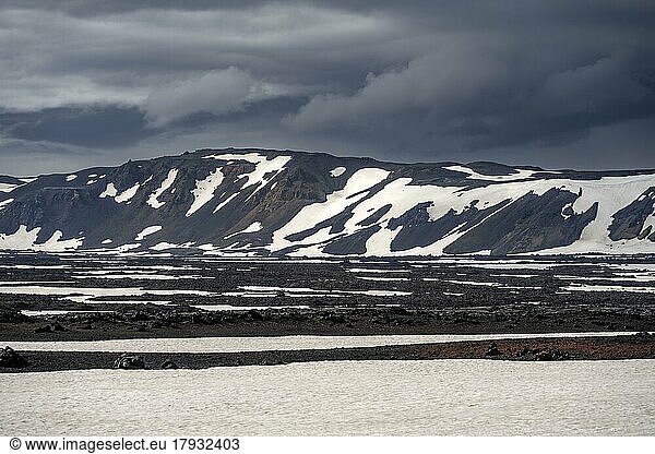 Snow-covered volcanic landscape with volcanic sand and petrified lava  crater of Askja volcano  Icelandic highlands  Iceland  Europe