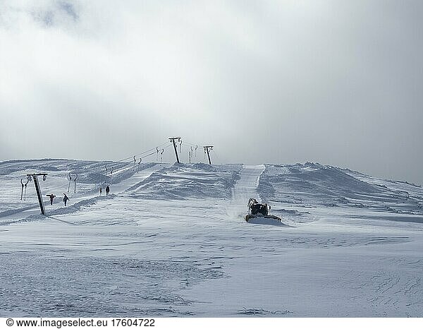 Snow groomer or Pistenbully levels ski slope  summit lift at Lawinenstein  Tauplitzalm  Styria  Austria  Europe