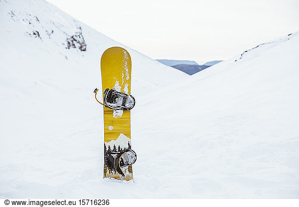 Snowboard on top of a snowy mountain