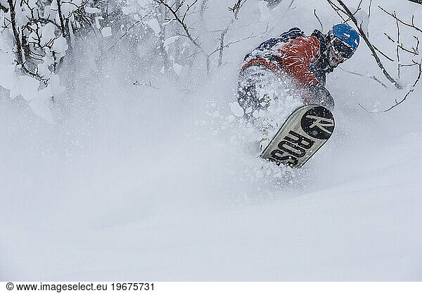 Snowboarder plowing thru fresh powder in Chamonix