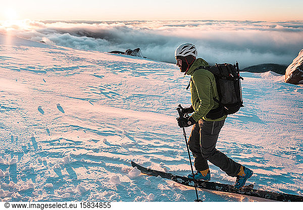 Snowboarder touring in backcountry during sunrise on Mount Hood