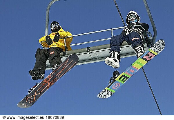 Snowboarders on a ski lift  Canada Olympic Park  COP  Calgary  Alberta  Canada  North America