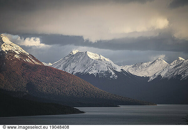 snowed peak with the first lights
