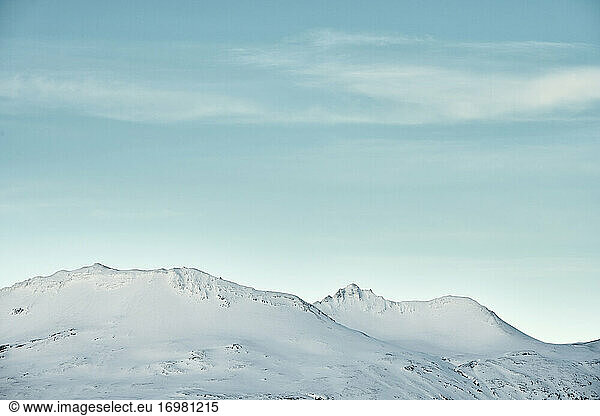 Snowy mountains against blue sky