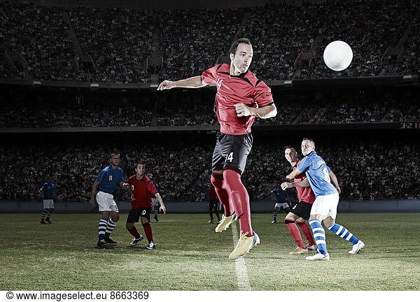 Soccer player jumping on field