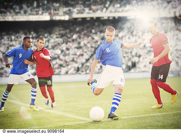 Soccer player kicking ball on field