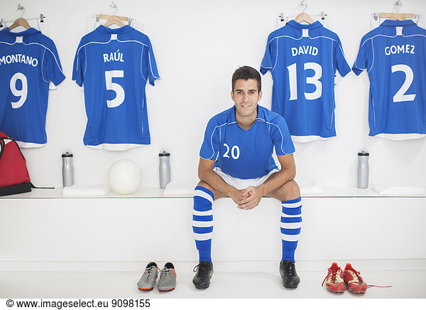 Soccer player sitting in locker room