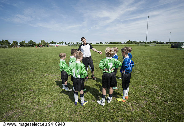 Soccer trainer junior football team practice