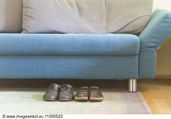 Sofa in living room with shoes