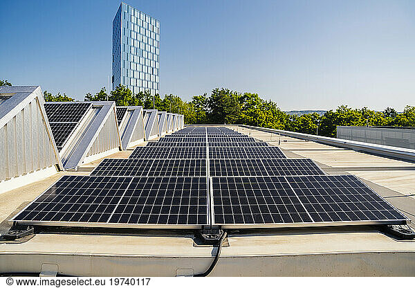 Solar panels installed on a rooftop  generating clean energy under a clear blue sky