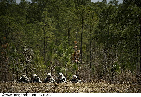 Soldiers in basic training move tactically as a squad during close quarters combat training.