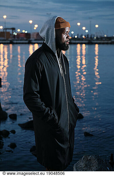 Solitude: African American Man Standing Alone near a Canal at Night