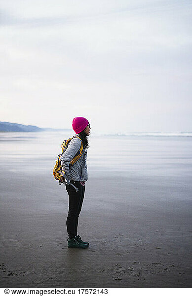 Solo Female Traveler on Oregon beach at sunrise
