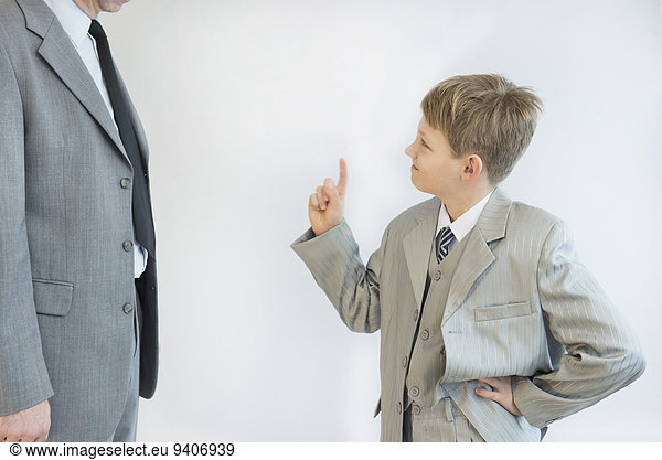 Son blusters his father against white background