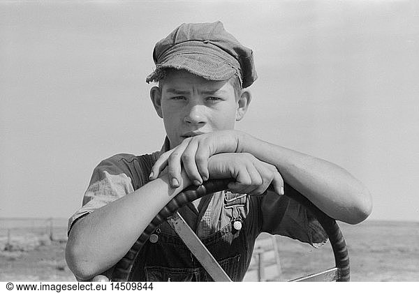 Son of Mr. Germeroth  FSA Client  Portrait Sitting at Steering Wheel of Tractor  Sheridan County  Kansas  USA  Russell Lee  Farm Security Administration  August 1939