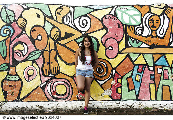 South America  Brazil  Pernambuco  Olinda  young woman leaning on painted wall