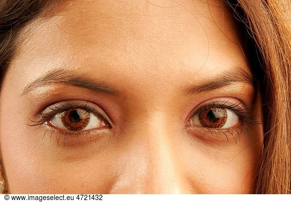 South Asian Indian teenager girl using red colour contact lenses in eyes MR686G