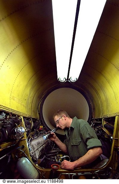 SOUTH BURLINGTON  Vt. (AFPN) -- Staff Sgt. Dave Custer inspects his F16 Fighting Falcon engine bay before the aircraft deploys. He is a crew chief with the Vermont Air National Guard. (U.S. Air Force photo by Master Sgt. Rob Trubia)