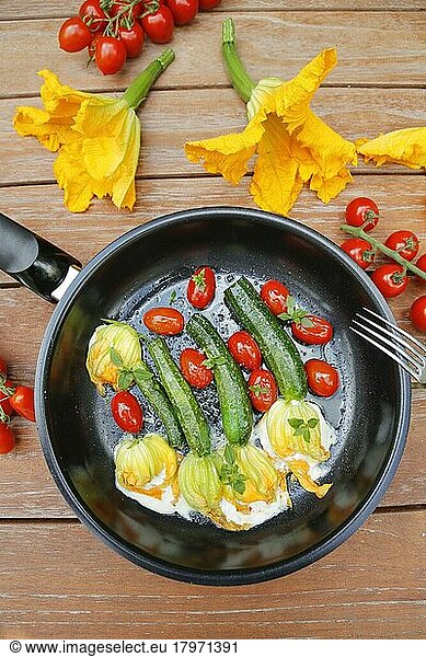 Southern German cuisine  stuffed courgette flowers sautéed in pan  cream cheese  cocktail tomatoes  cherry tomatoes  vegetarian  healthy cuisine  vegetables  fork  Germany  Europe