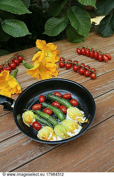 Southern German cuisine  stuffed courgette flowers sautéed in pan  cream cheese  cocktail tomatoes  cherry tomatoes  vegetarian  healthy cuisine  vegetables  Germany  Europe