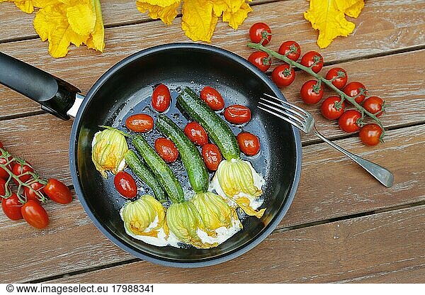 Southern German cuisine  stuffed courgette flowers sautéed in pan  cream cheese  cocktail tomatoes  cherry tomatoes  vegetarian  healthy cuisine  vegetables  fork  Germany  Europe