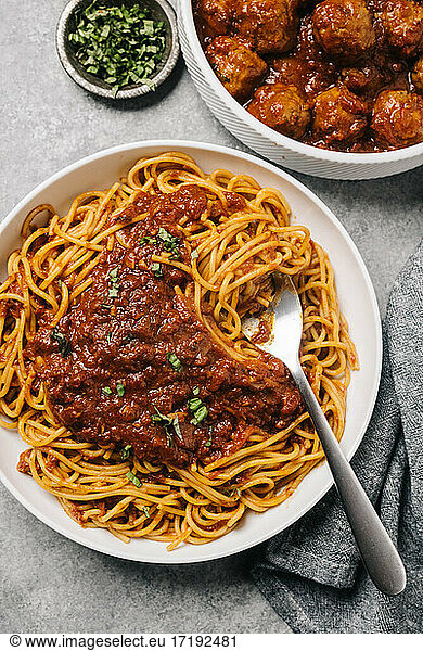 Spaghetti marinara with a side dish of meatballs