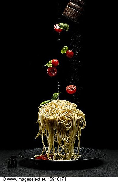 Spaghetti with tomatoes  cocktail tomatoes and basil  oil  olive oil  plates  food photography  studio photography  South Tyrol  Italy  Europe