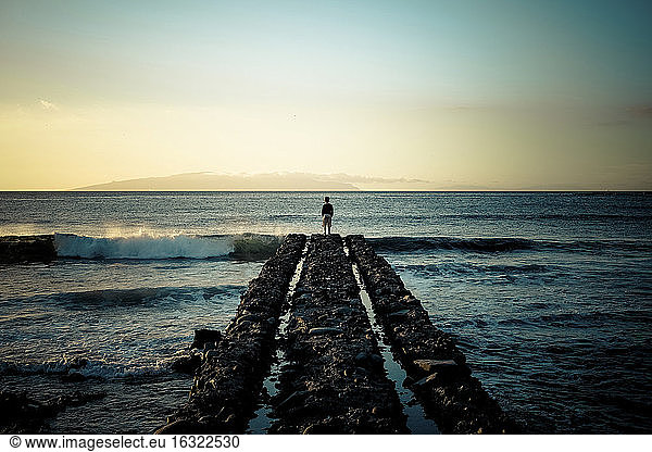 Spain, Canary Islands, Tenerife, back view of child standing at pier looking at the sea, Spain, Canary Islands, Tenerife, back view of child standing at pier looking at the sea