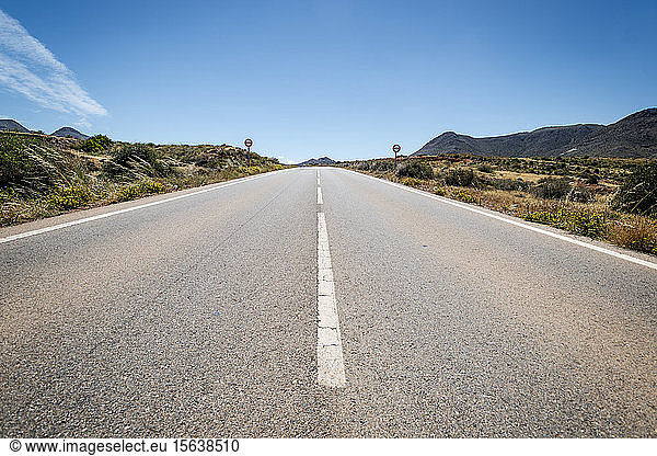 Spain  Andalusia  Cabo de Gata  Diminishing perspective of empty highway on sunny day