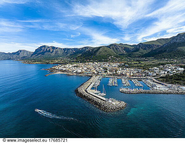 Spain  Balearic Islands  Colonia de Sant Pere  Helicopter view of coastal town in summer with mountains in background