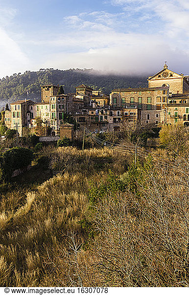 Spain  Balearic Islands  Mallorca  Valldemossa  S'Arxiduc  View to village with chartreuse  Carthusian monastery