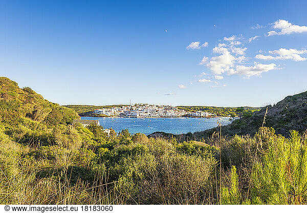 Spain  Balearic Islands  Menorca  Coastal village seen from grassy hill in summer
