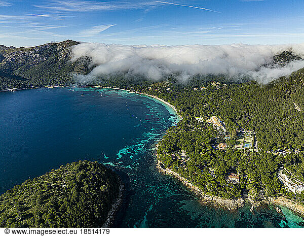 Spain  Balearic Islands  Port de Pollenca  Aerial view of Mediterranean coastline with thick fog floating in background