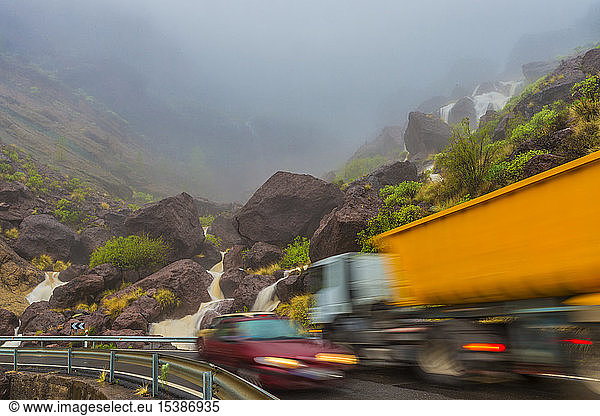 Spain  Canary Islands  Gran Canaria  Veneguera  truck and car on mountain pass at waterfall Los Azulejos