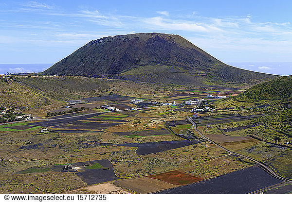 Spain  Canary Islands  Guinate  Fields in front of rural village with Monte Corona volcano looming in background