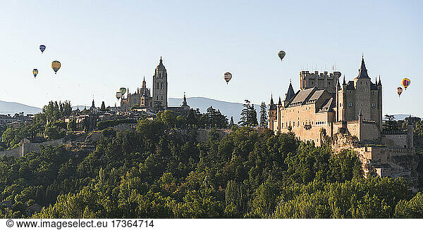 Spain  Castile and Leon  Segovia  Hot air balloons flying Segovia Cathedral and Alcazar of Segovia