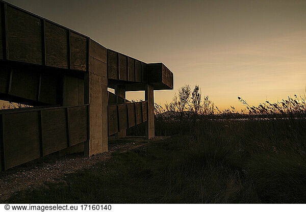 Spain  Ebro Delta  Sunset over landscape with architecture element