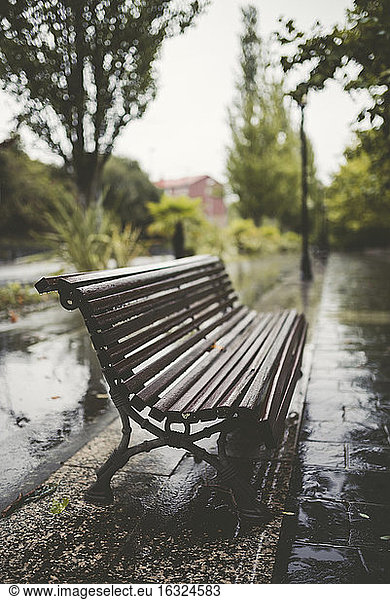 Spain  Galicia  Ferrol  Bench in a promenade  rain