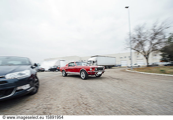 Spain  Madrid  Blurred motion of red-colored vintage sports car