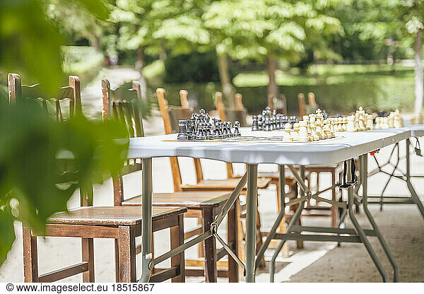 Spain  Madrid  Empty chairs in front of outdoor chess tables in El Retiro Park